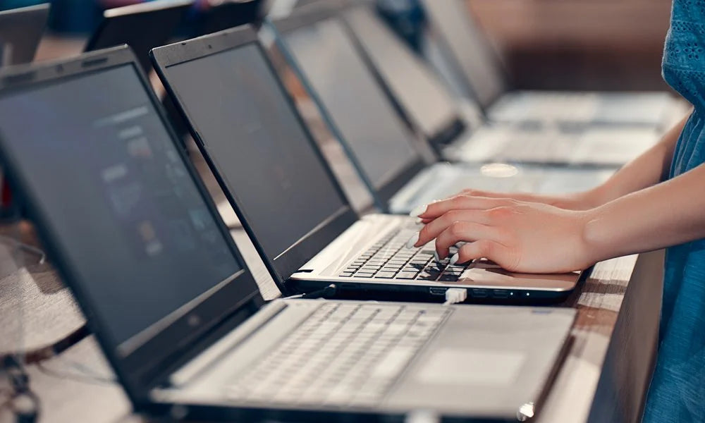 Someone testing out a laptop before buying it