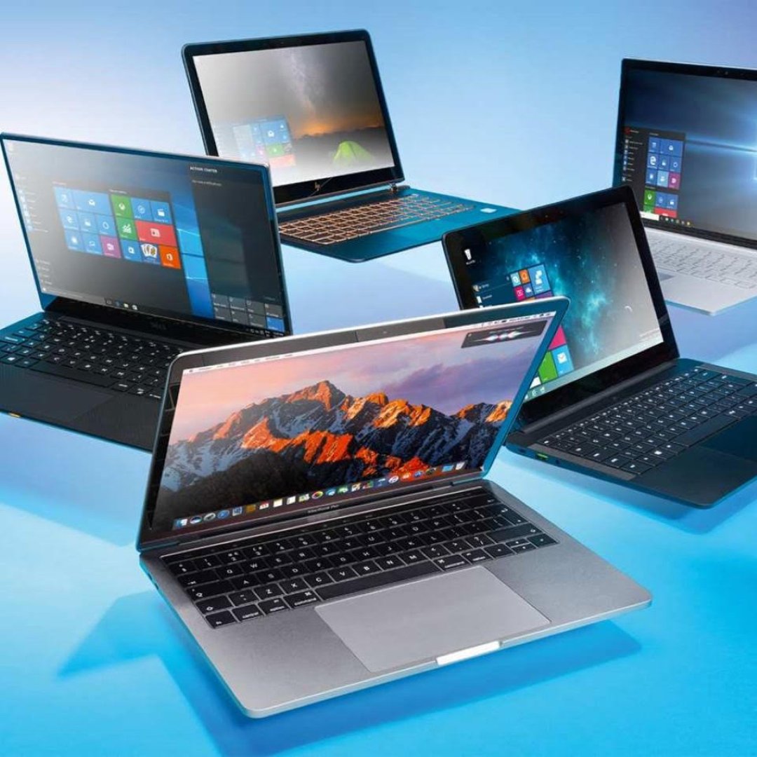 Group of laptops of various brands and sizes.